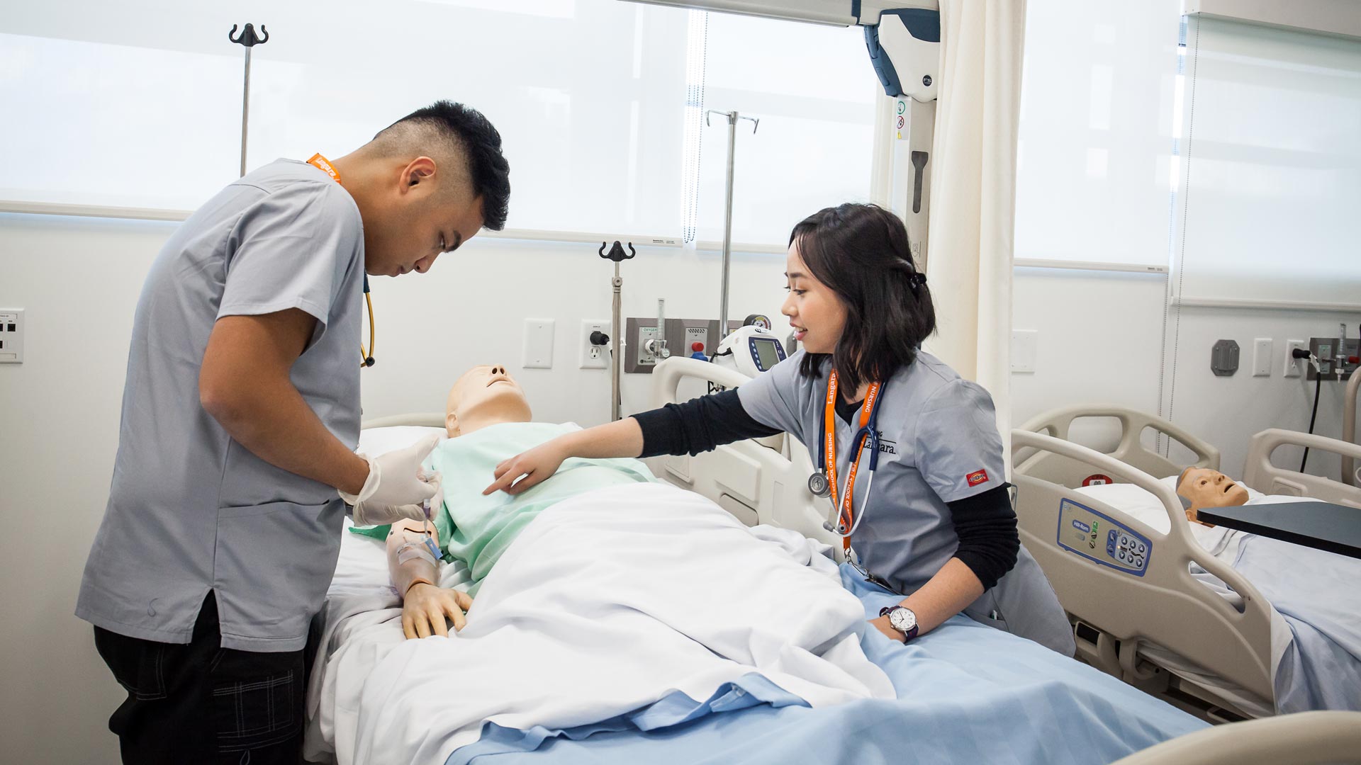 Langara students practice nursing skills in a modern nursing lab.