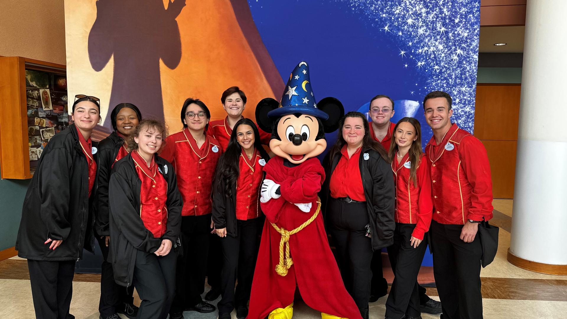Students pose with Mickey Mouse in his Fantasia regalia.