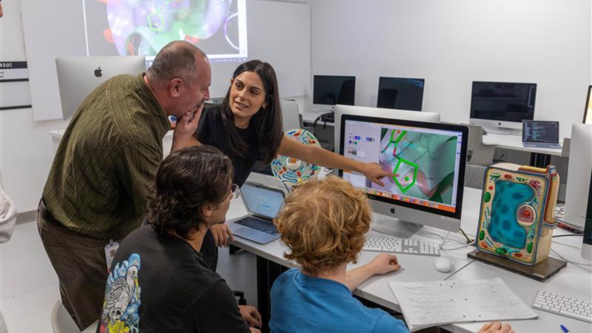 Instructors and students in a computer lab.