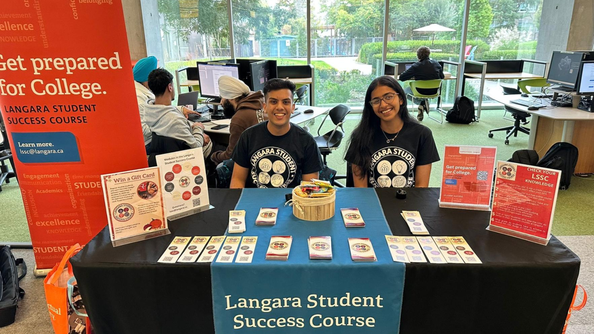 BBA student Vansh Gupta with a friend at a display table.