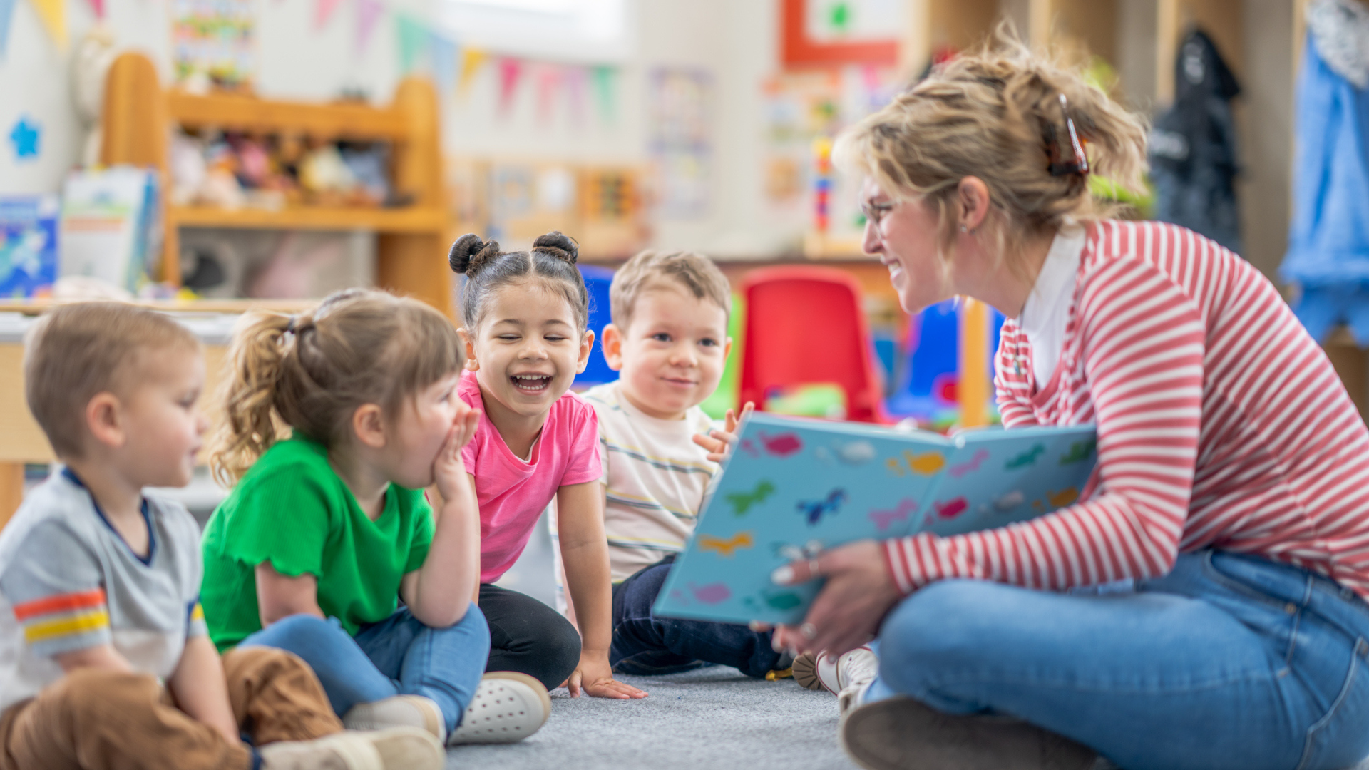 Early childhood educator with four students.