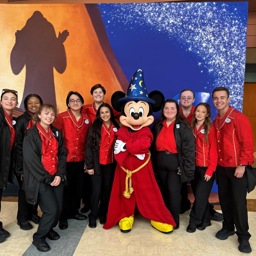 Students pose with Mickey Mouse in his Fantasia regalia.