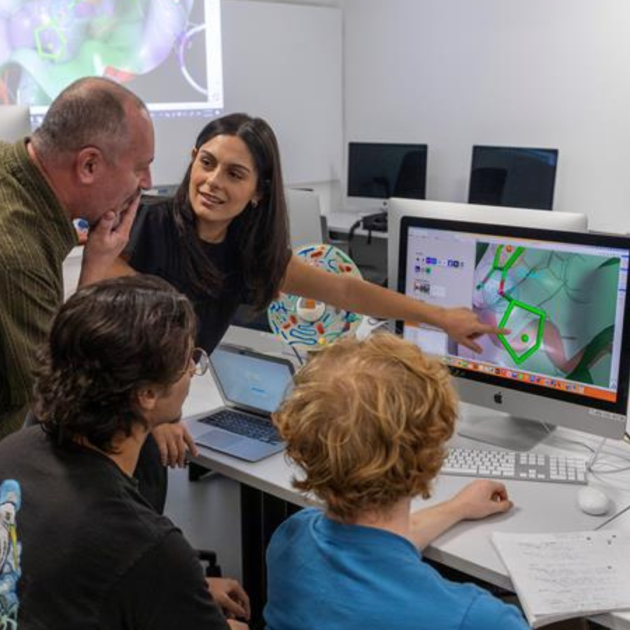 Instructors and students in a computer lab.