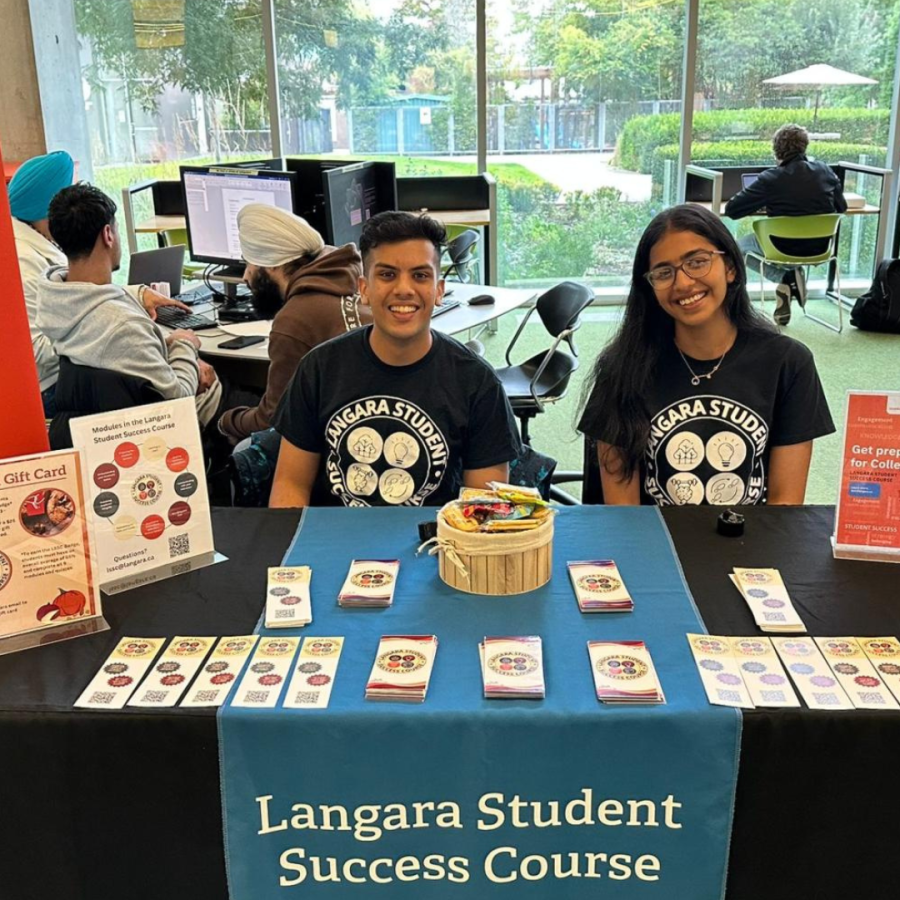 BBA student Vansh Gupta with a friend at a display table.