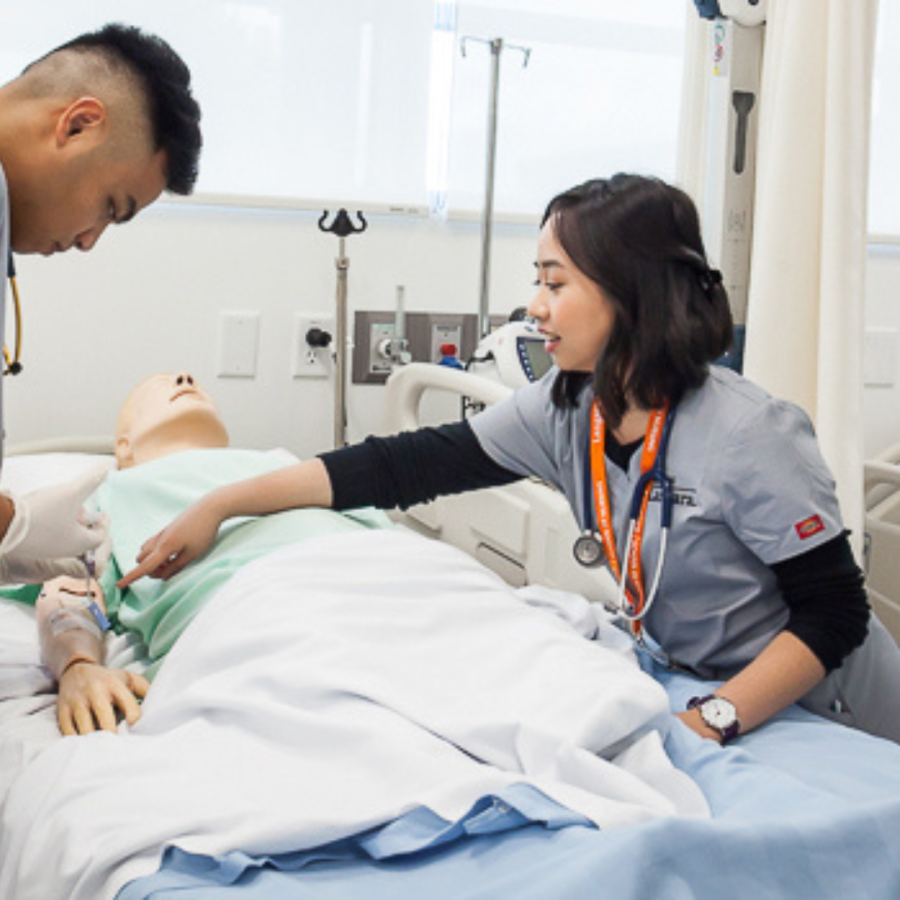 Two nurses with a mannequin
