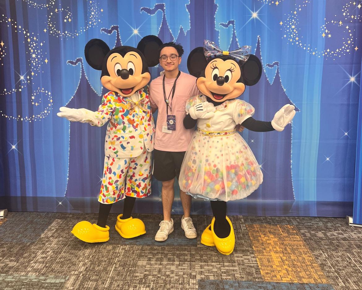 Paco Rodrigo poses with Mickey and Minnie Mouse.
