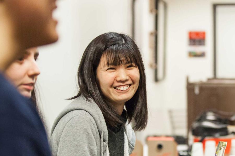 International student smiling at a community event