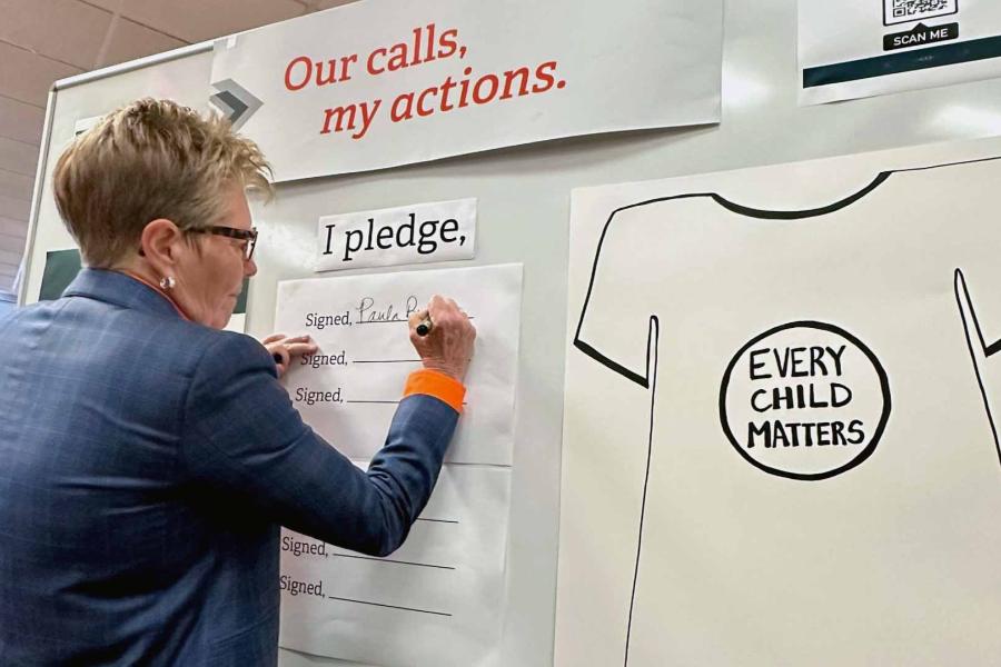 President Paula Burns takes a significant step forward as she signs a heartfelt pledge dedicated to actions and reconciliation.
