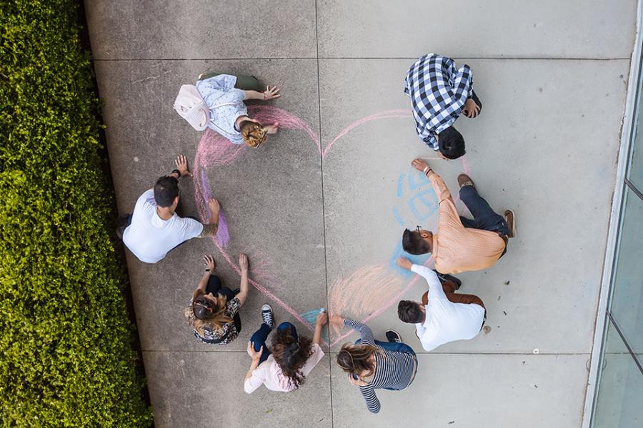 Students drawing a heart to celebrate the great tuition costs at Langara.